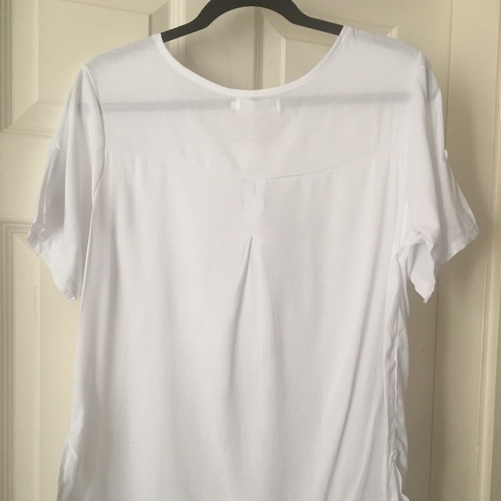 New White short sleeve top not sure of material.